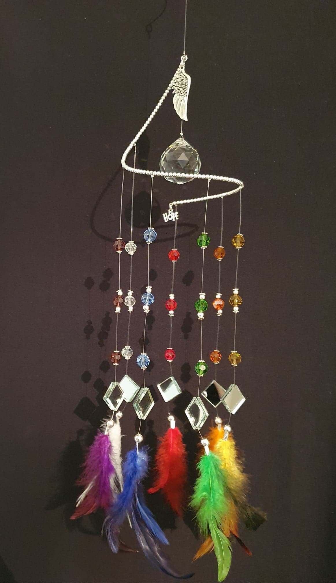 Rainbow suncatcher of "HOPE" with matching colour feathers. Large Angel wing.