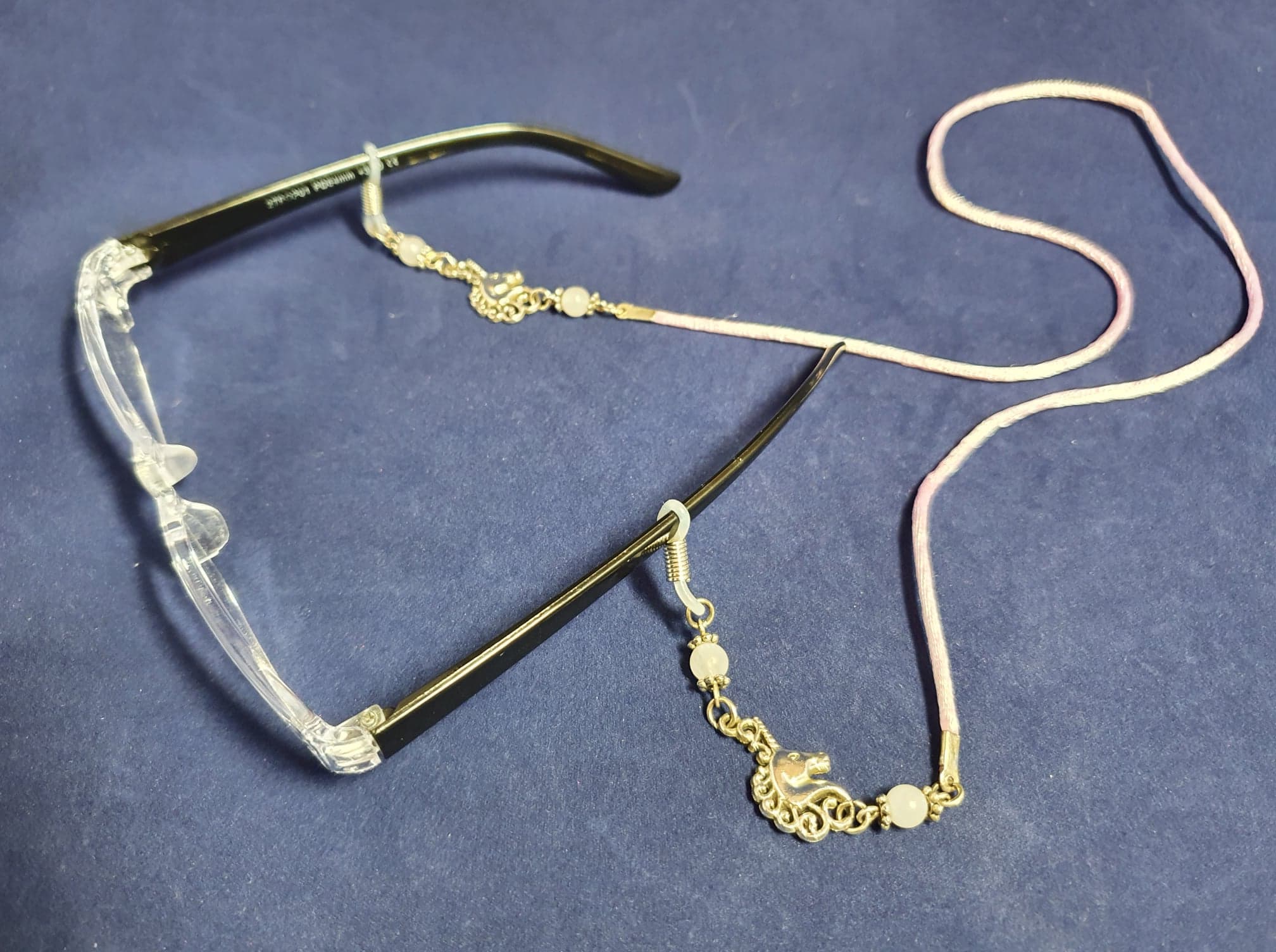 Glasses chain with unicorn charms and Rose Quartz. Pink satin cord.